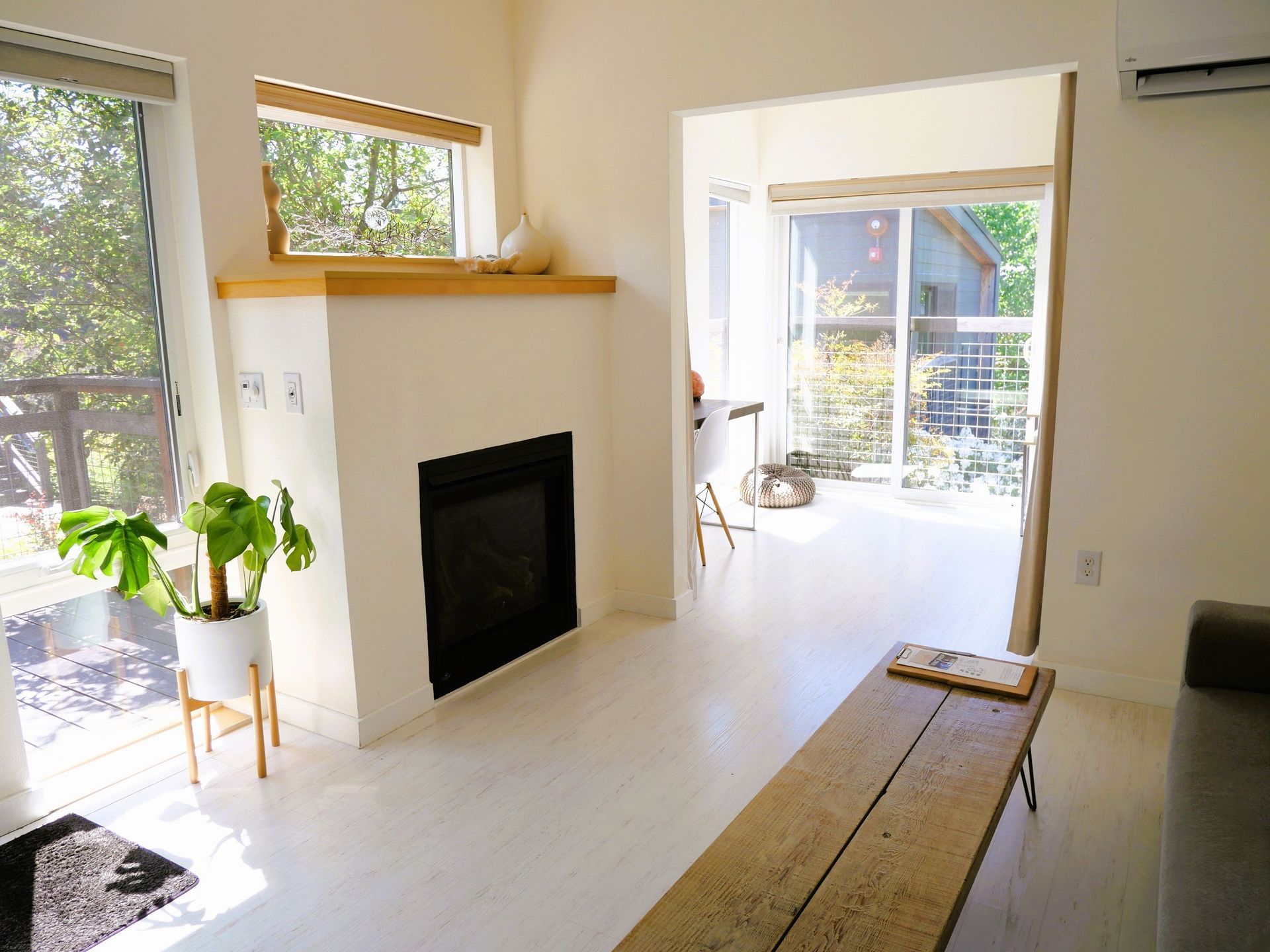 Interior of Courtyard King Lodge featuring a fireplace, soaking tub, and cozy seating on Vashon Island.