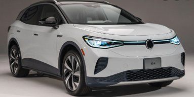 White Volkswagen ID.4 electric SUV, front view. Black trim, stylized headlights, and front emblem.