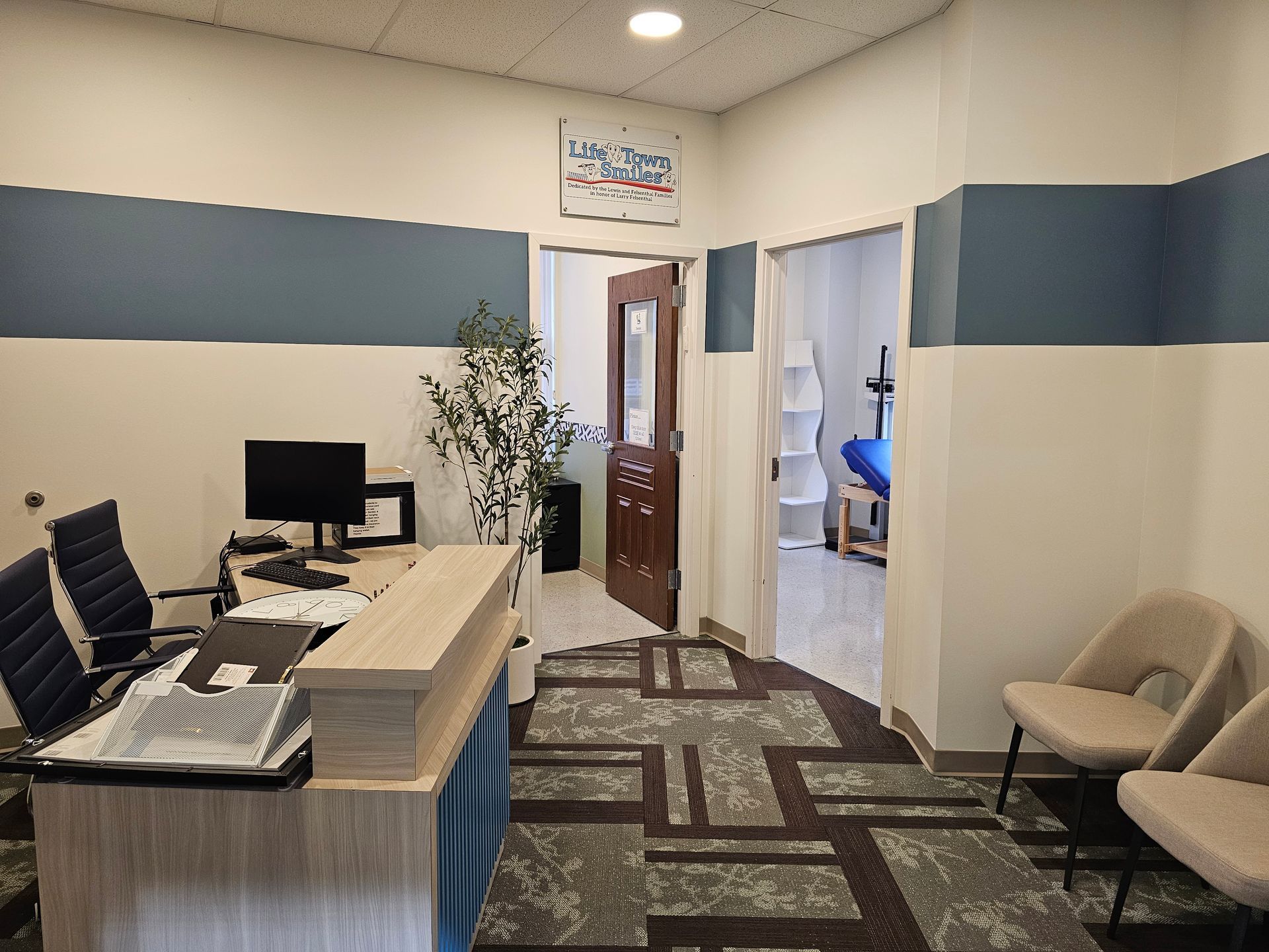Reception area with desk, blue curtain, carpet, and an open door. New Albany commercial interior painting project. 