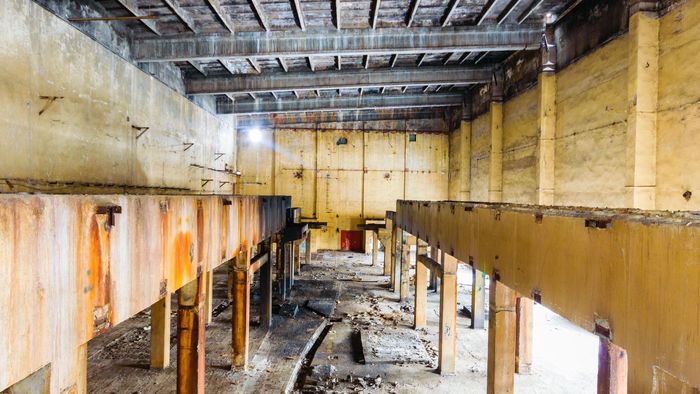 an abandoned building with lots of wood and rust