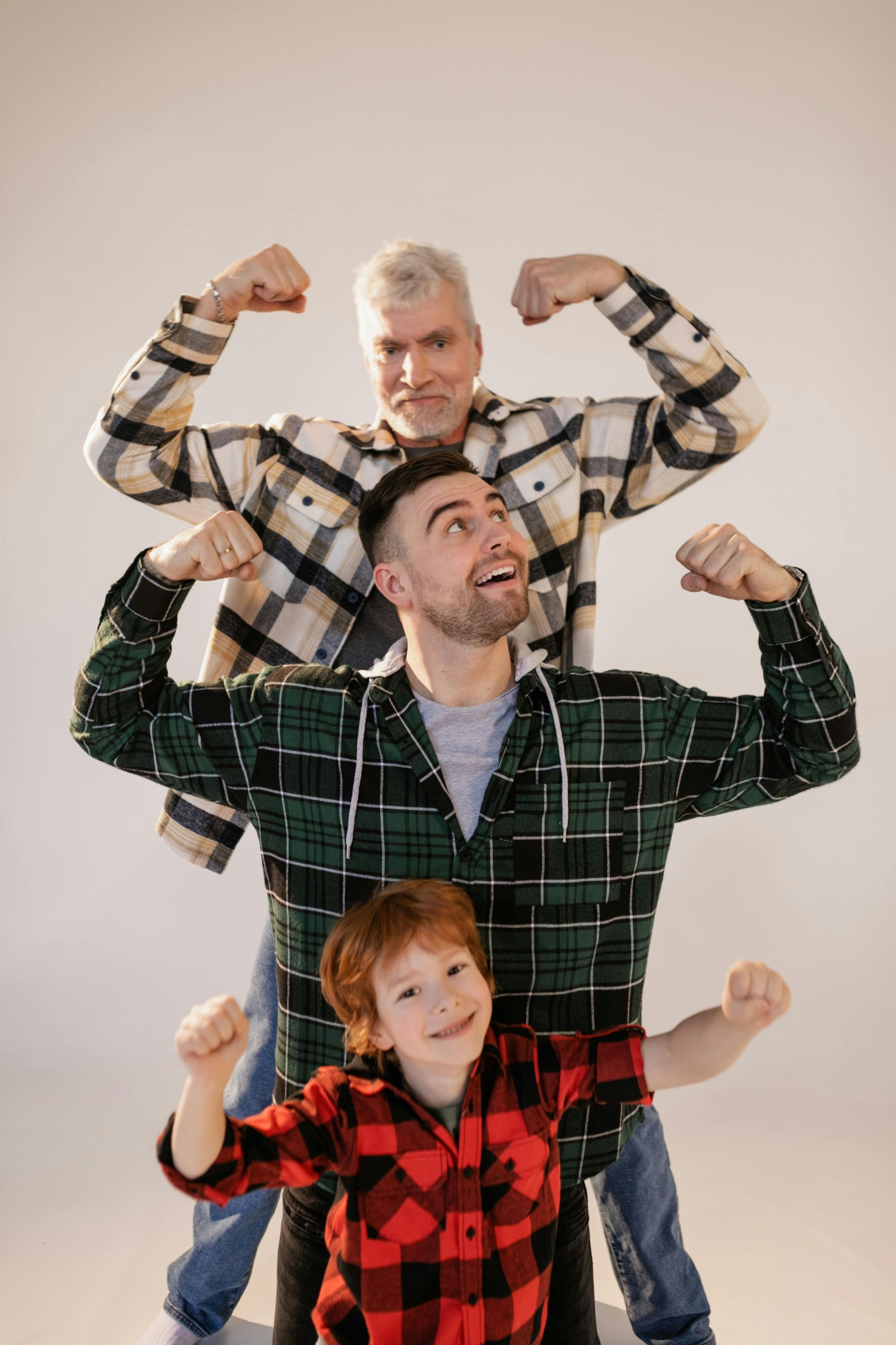 three generations of men facing the camera and smiling 
