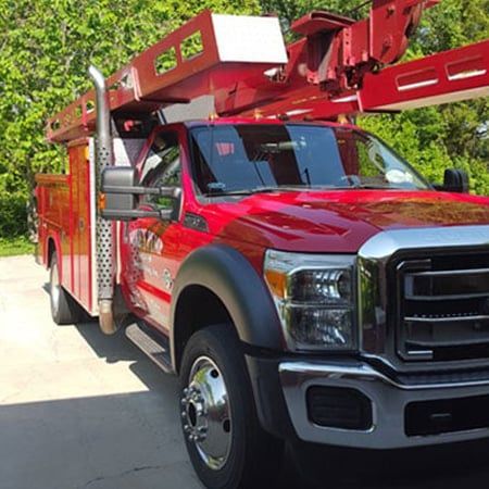 Red Plumbing and Drilling Truck For Water Treatment System Installation Viewed From An Angle