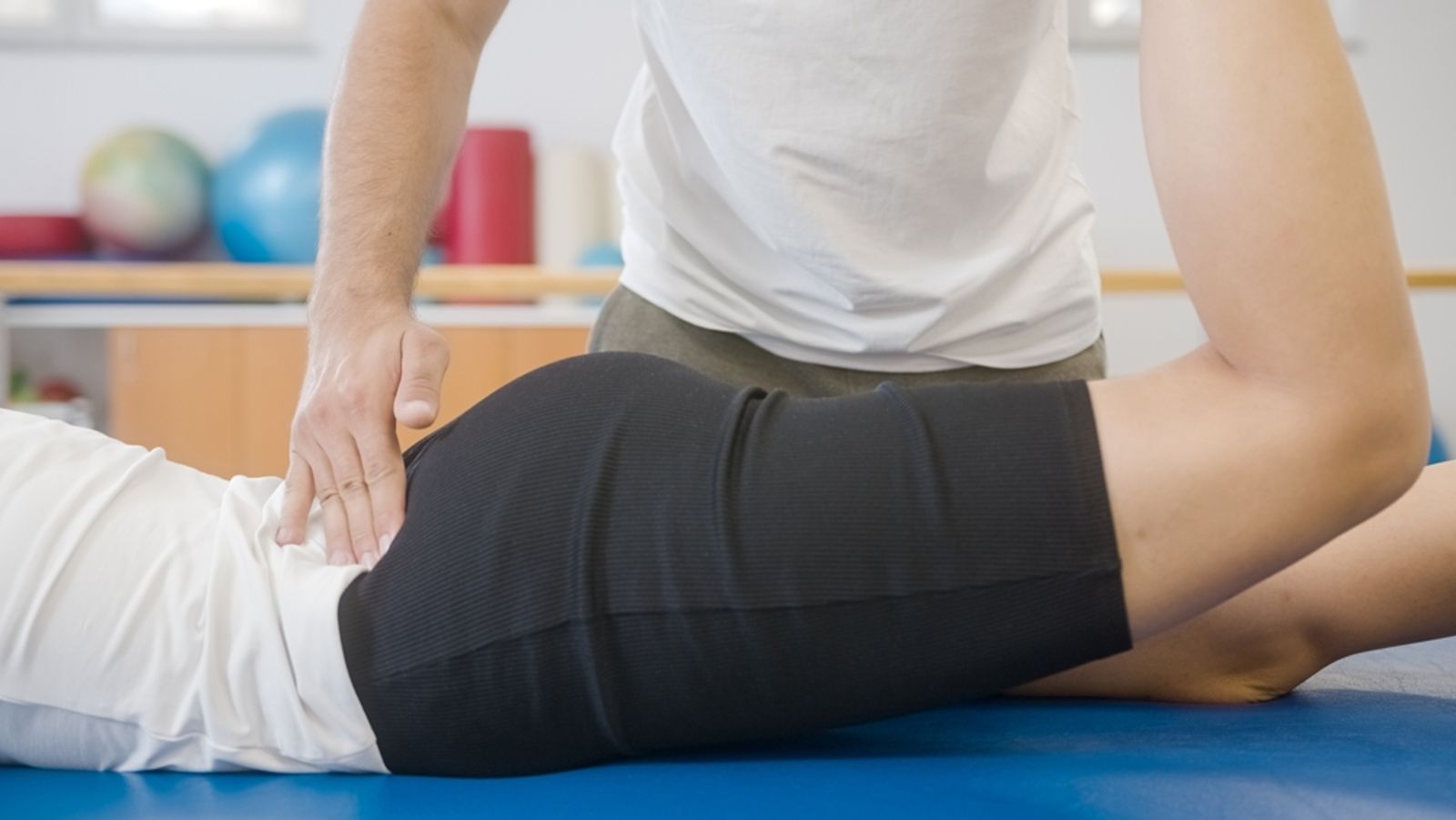 physiotherapist treating lower back pain patient in Mississauga clinic