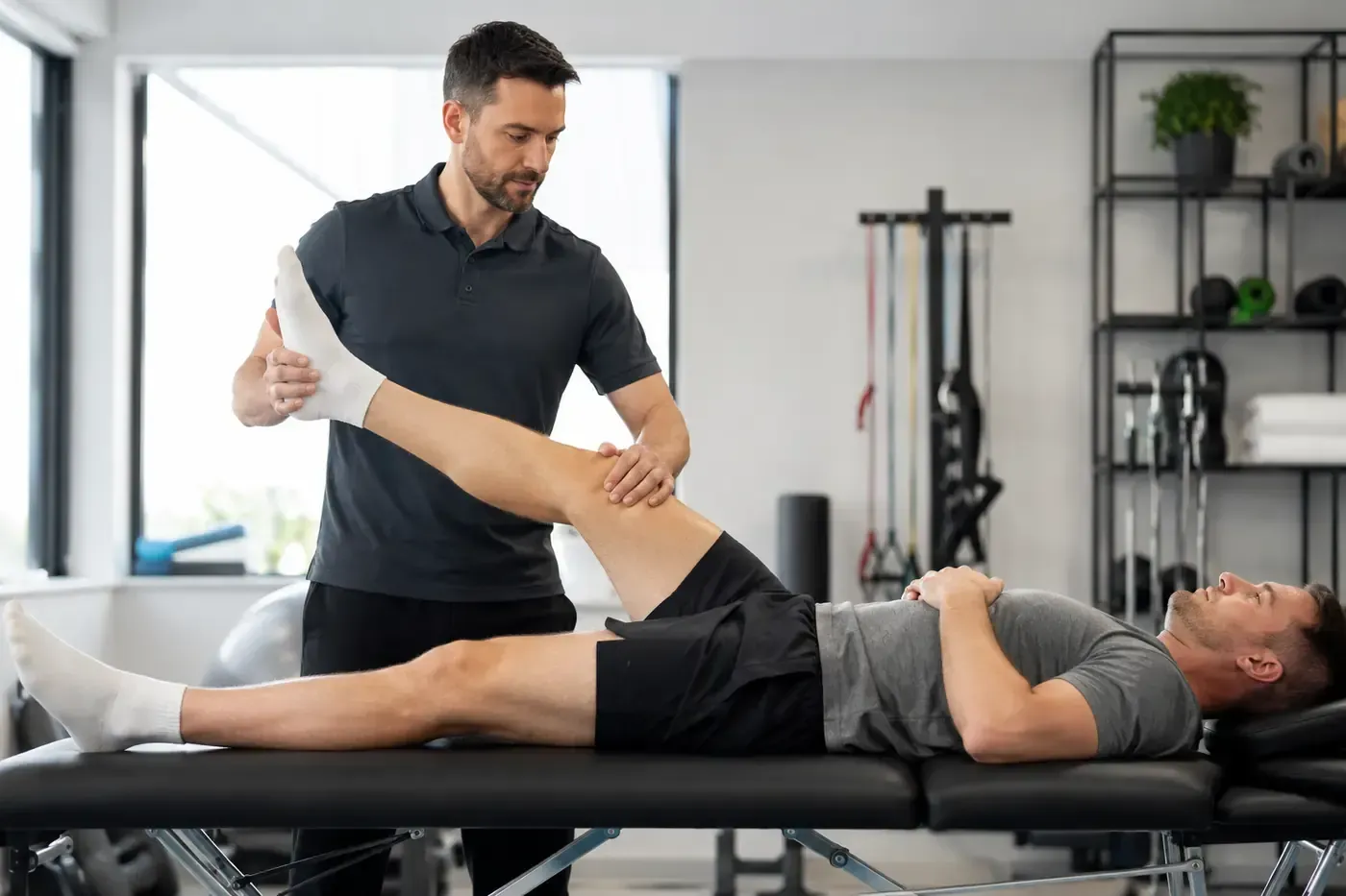 Physiotherapist performing a leg assessment for sciatica-related symptoms at a physiotherapy clinic 