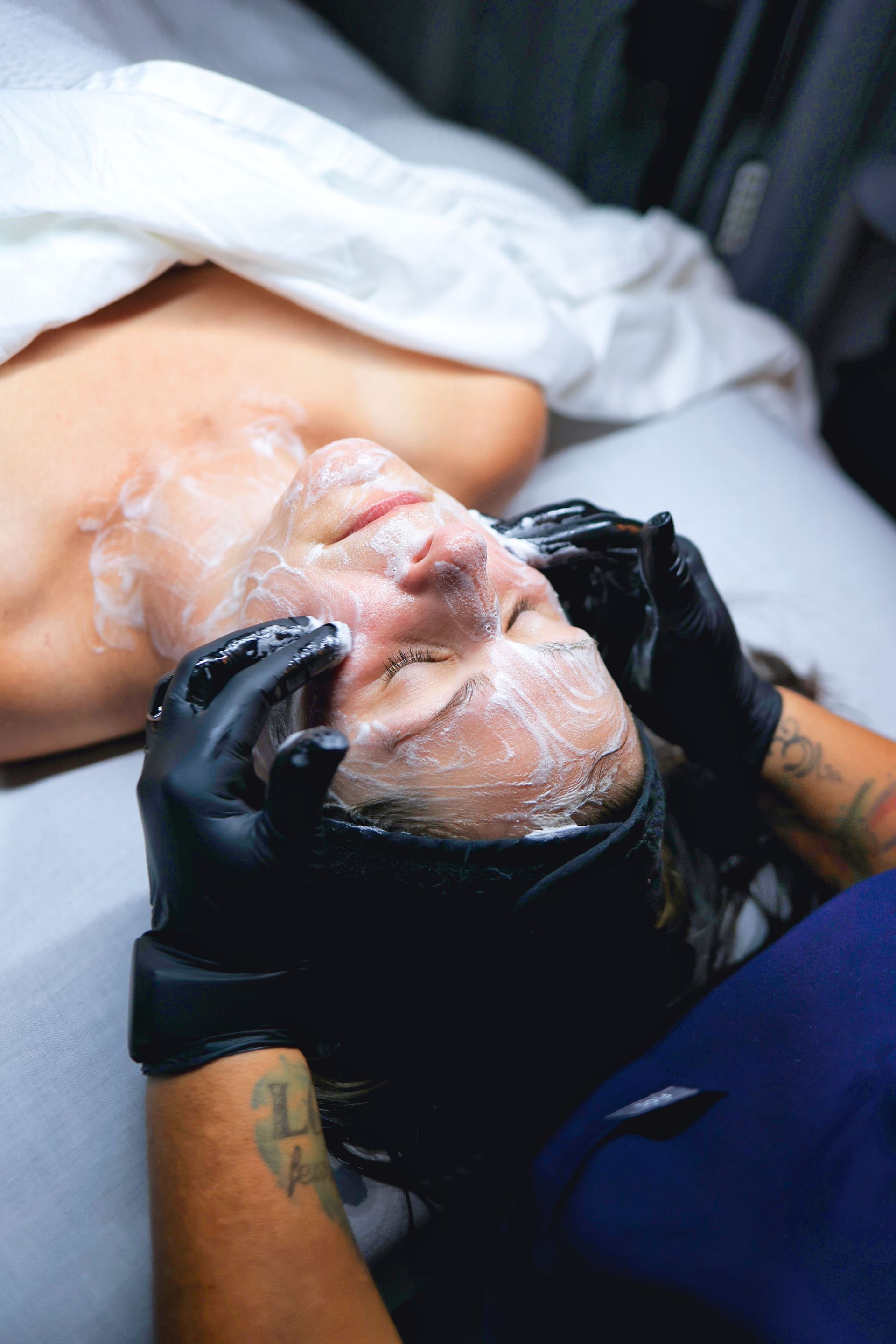 Esthetician applying a custom mask during an express facial at Hans Esthetics in Plainfield, IL