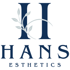 HANS Esthetics logo with navy-blue initials and light gray leaf accents