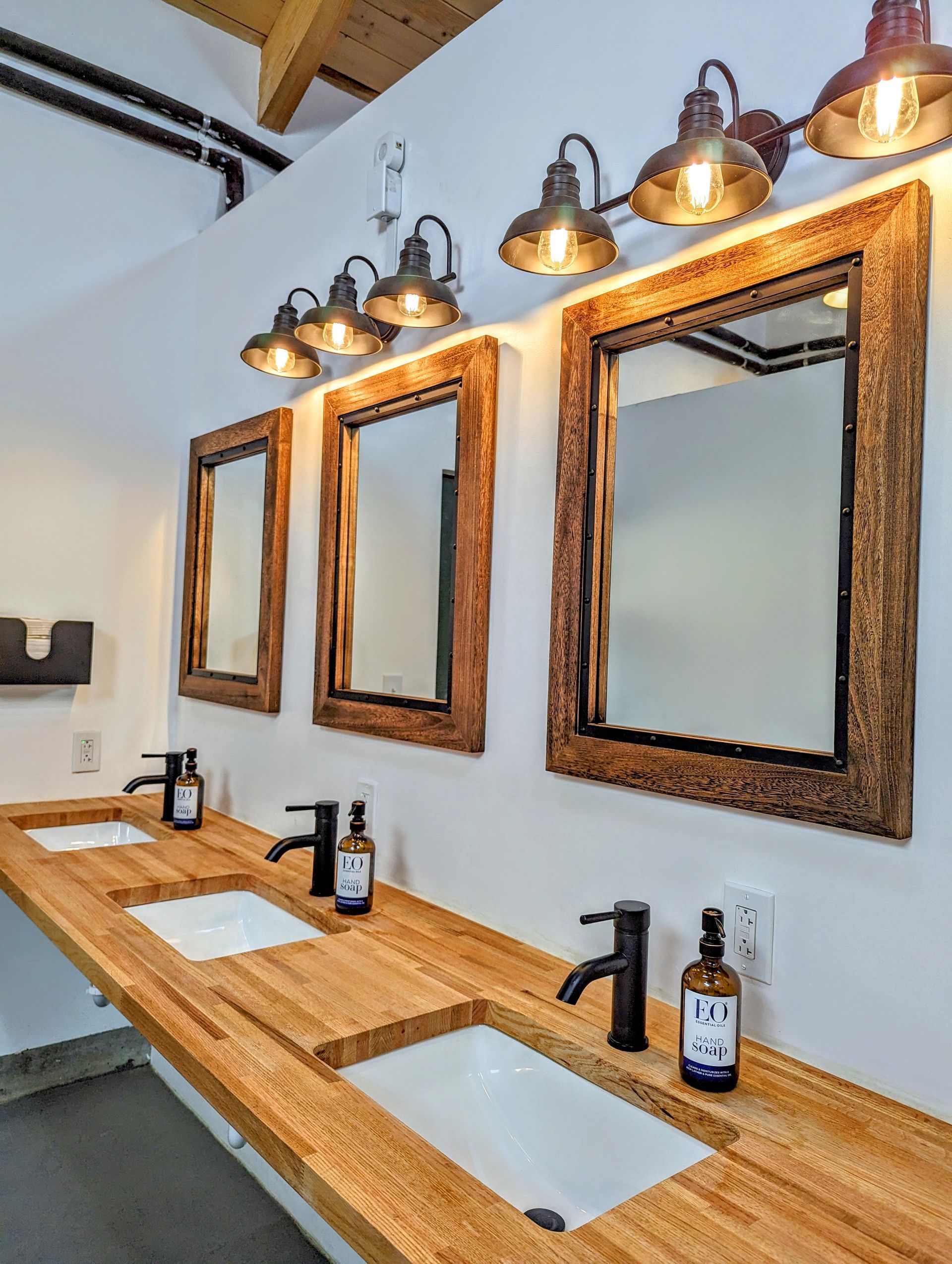 A bathroom with a row of sinks and mirrors
