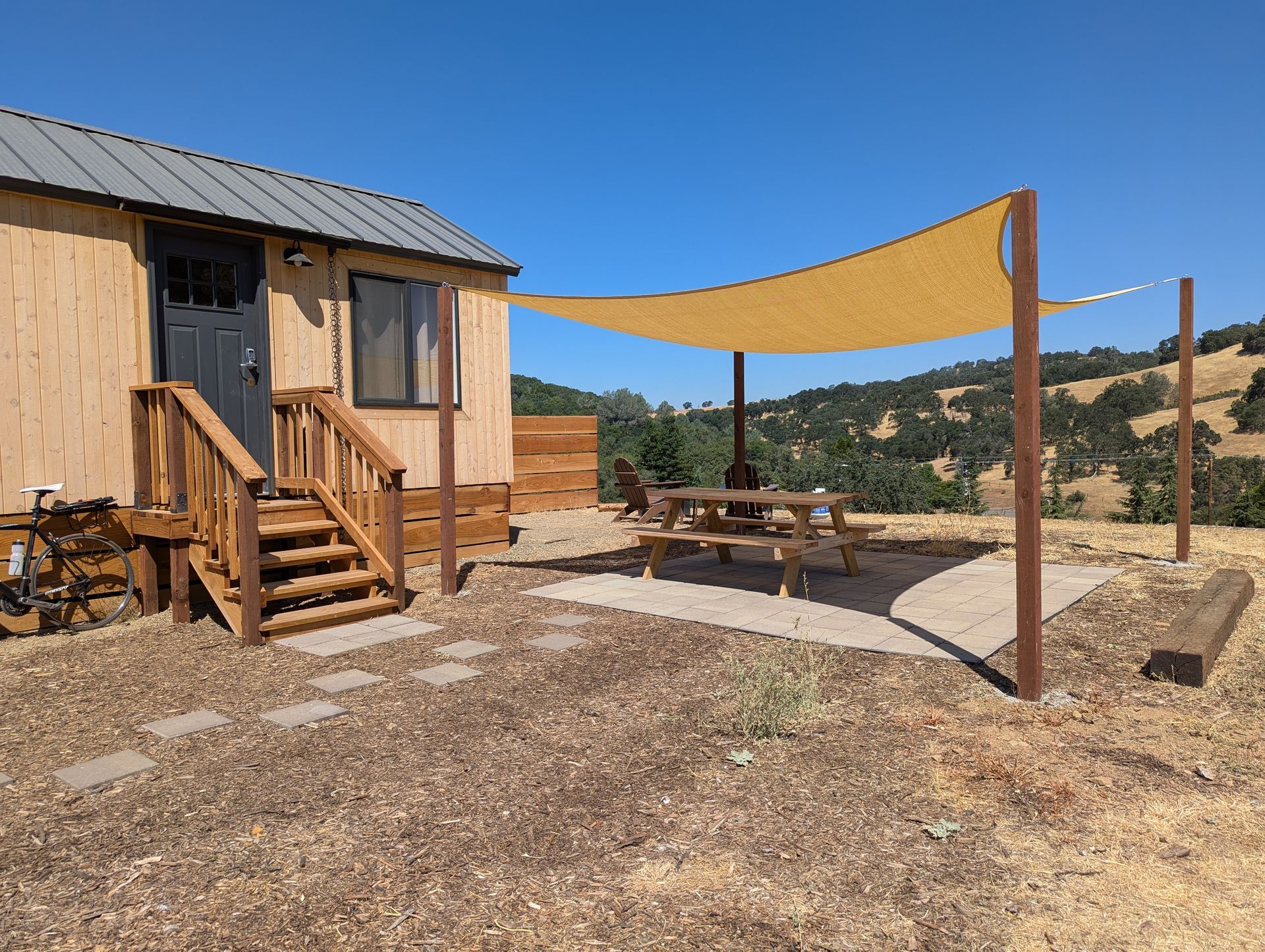 A small house with a picnic table under a canopy
