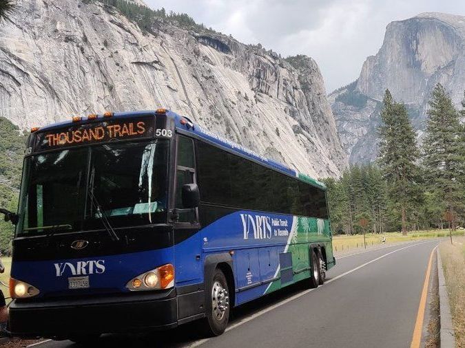 A bus that says thousand trails on the front of it
