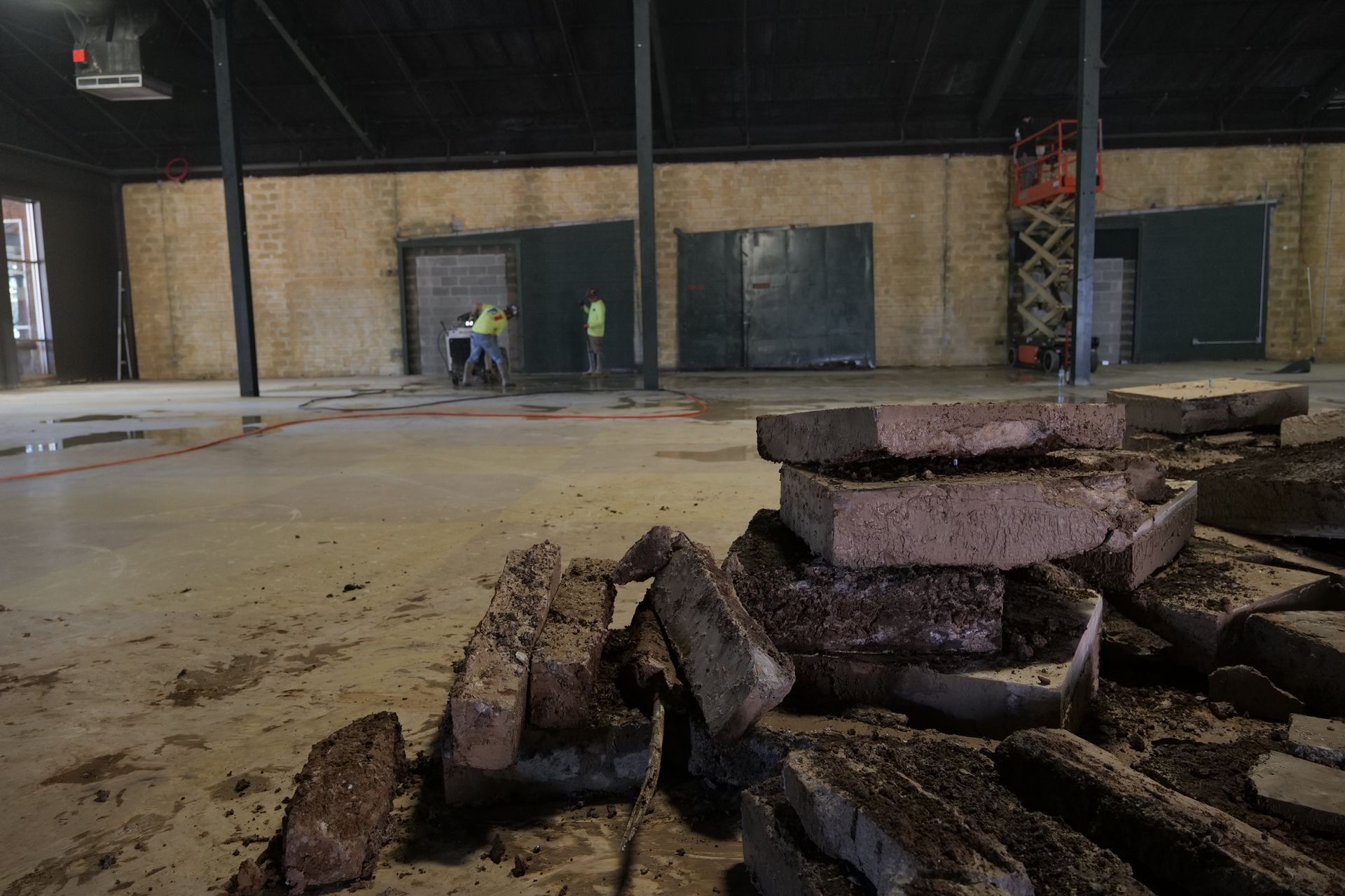 A pile of concrete is sitting on the floor of a building.