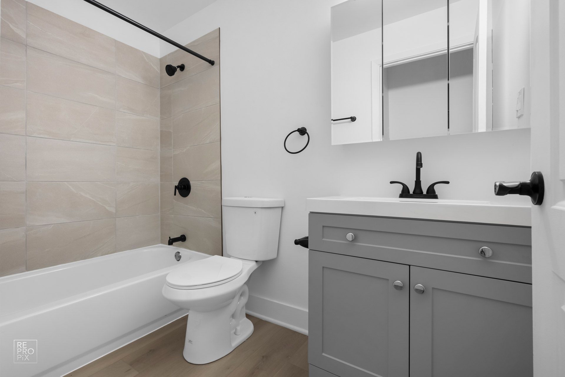A bathroom with a toilet , sink and bathtub