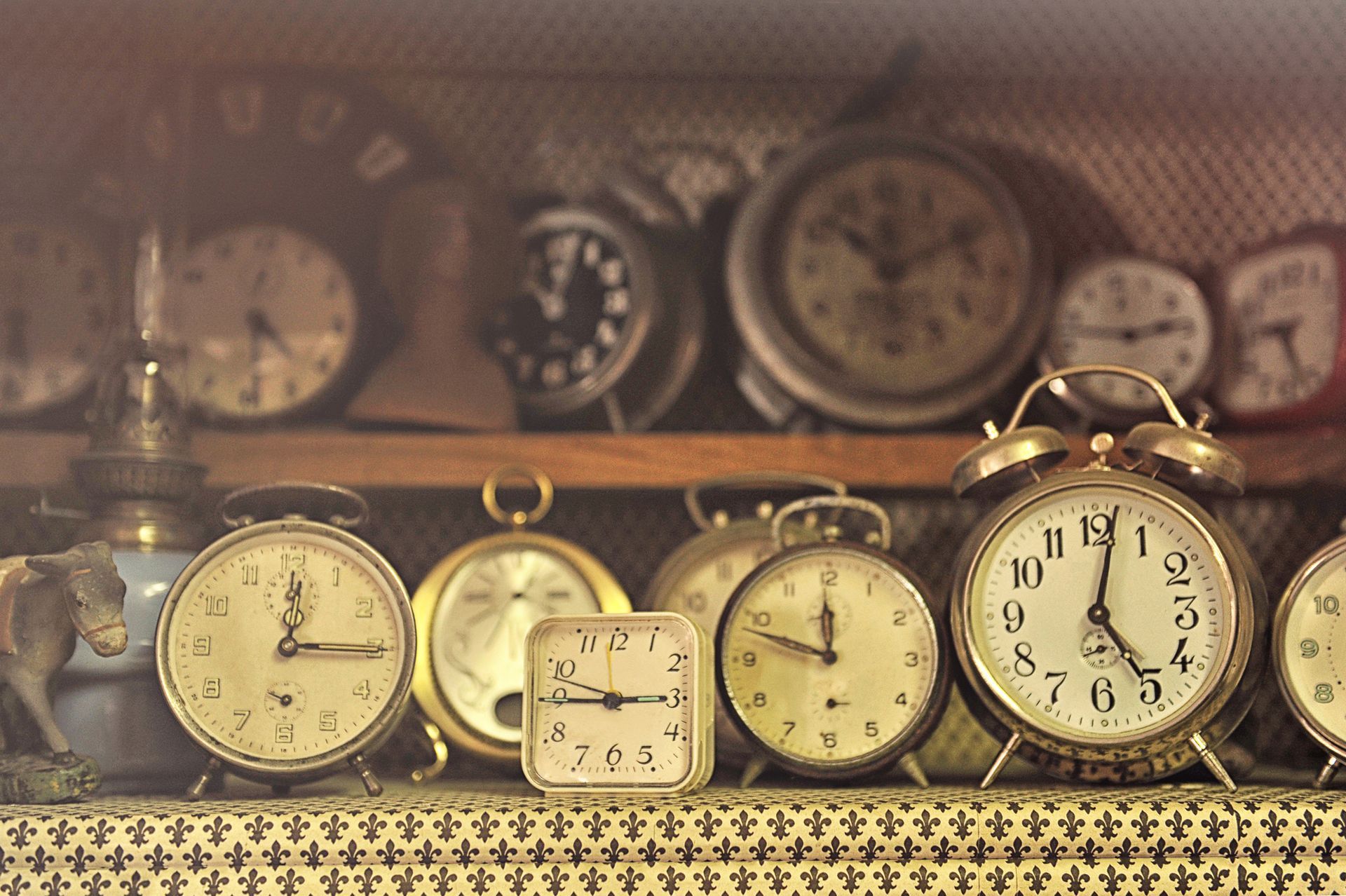 Old-fashioned alarm clocks with unique designs—sell antiques and vintage decor for collectors.