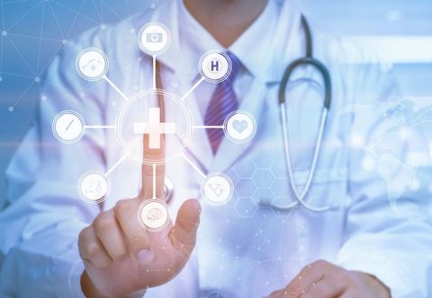A doctor is pressing a button on a virtual screen.