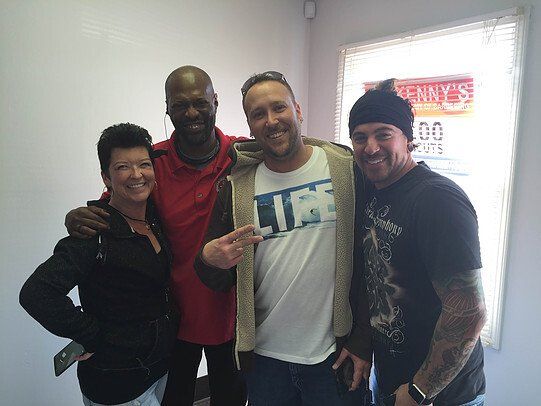 A group of people posing for a picture with one man wearing a life shirt