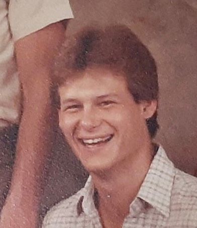 Pierre smiling in old photograph.