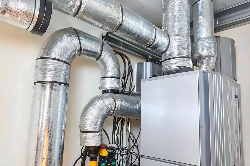 Air conditioning units with toolbox and gloves in backyard.