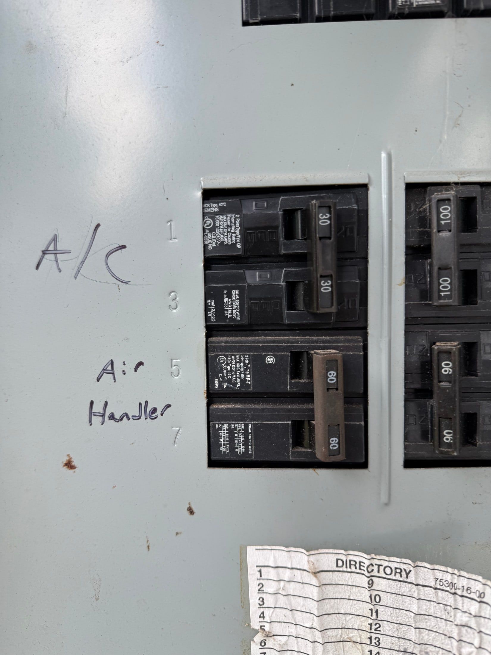 Electrical breaker panel labeled “A/C” and “Air Handler” with handwritten notes.