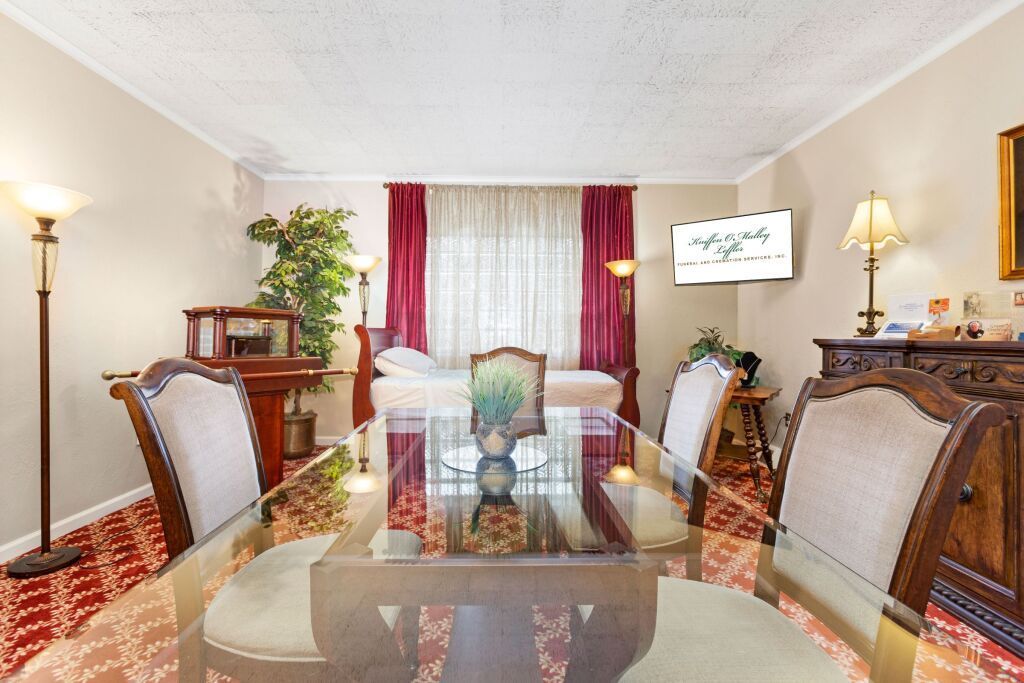 A living room with a glass table and chairs