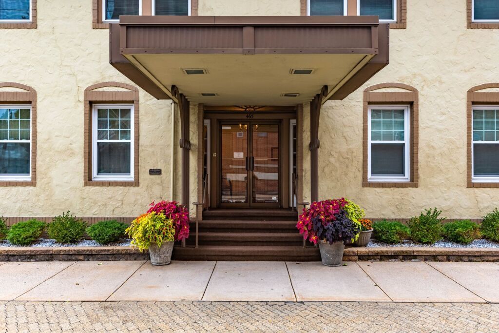 The front of a building with flowers in front of it