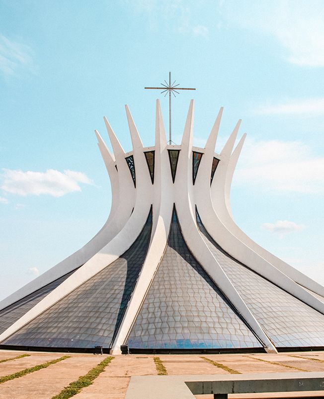 A large white building with a cross on top of it.