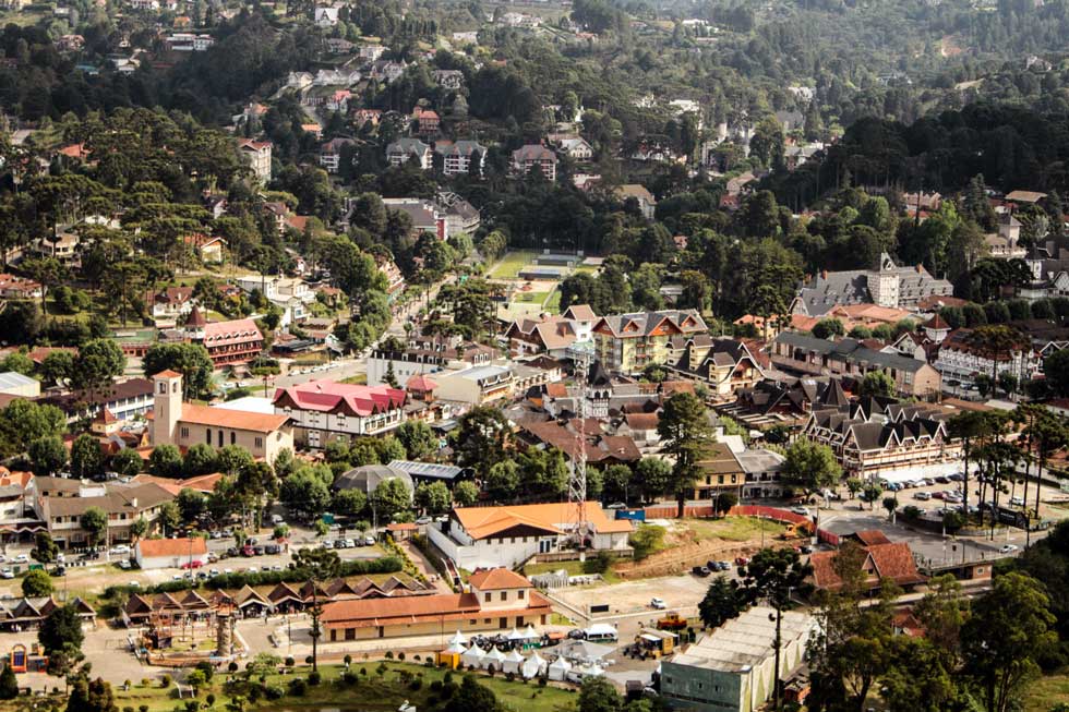 An aerial view of a small town surrounded by trees