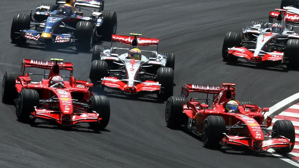 A group of race cars are racing on a race track