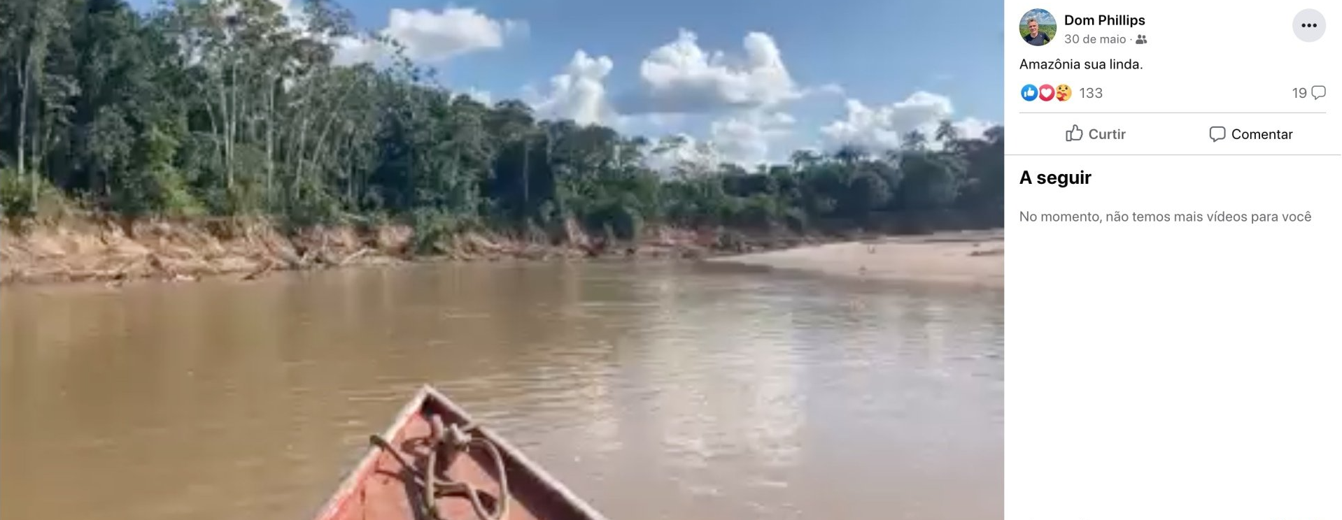 A boat is floating on top of a river surrounded by trees.