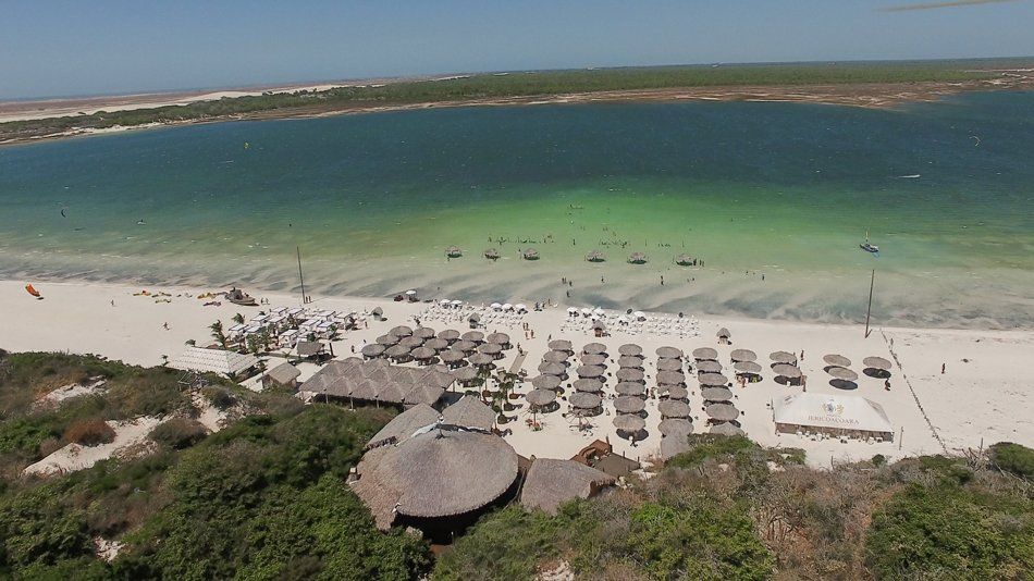 An aerial view of a beach with a lake in the background
