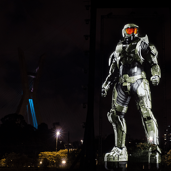 A statue of a halo soldier is lit up at night
