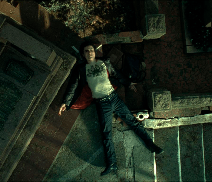 A man laying on the ground wearing a t-shirt that says 666