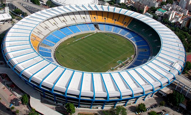 An aerial view of a soccer stadium with blue and yellow seats