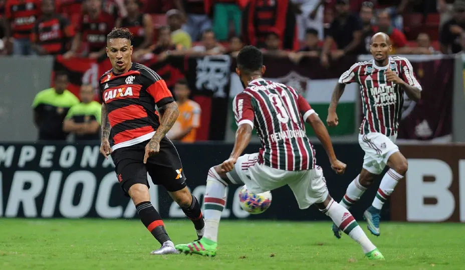 A group of soccer players are playing a game on a field.