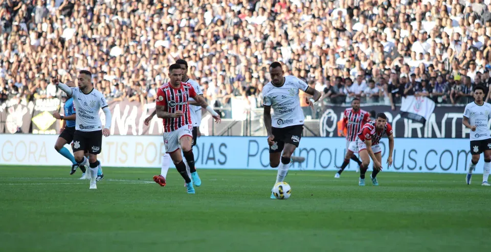 A group of soccer players are playing a game on a field.