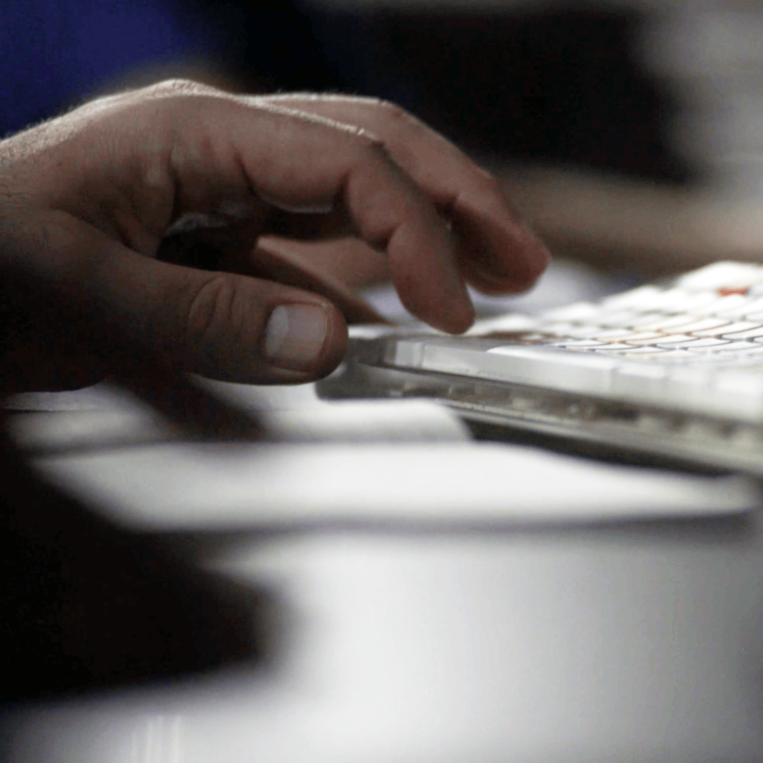 A close up of a person 's hand typing on a keyboard