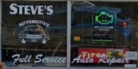 Steve’s Automotive storefront with “Full Service” and “Fire Auto Repair” signs and a neon engine light sign