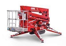 Piattaforma aerea ragno CMC 18 rossa su cingoli e stabilizzatori. Una piattaforma per i lavoratori.
