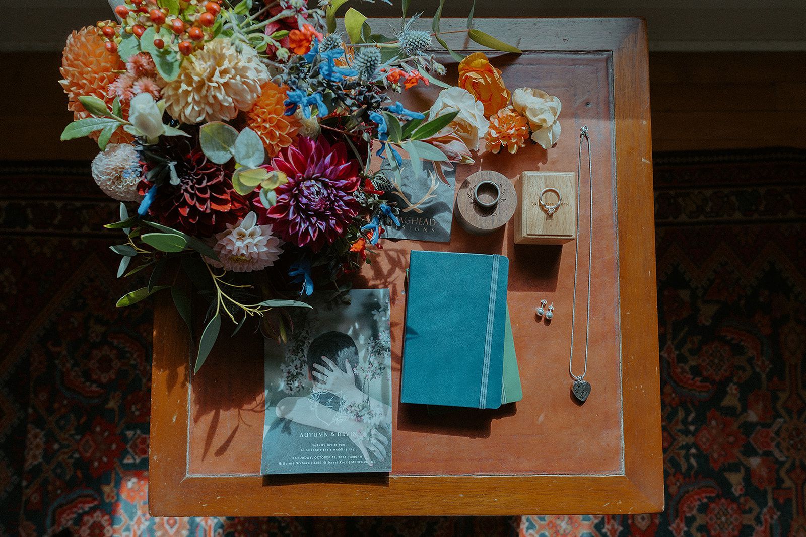A table with a bouquet of flowers and jewelry on it