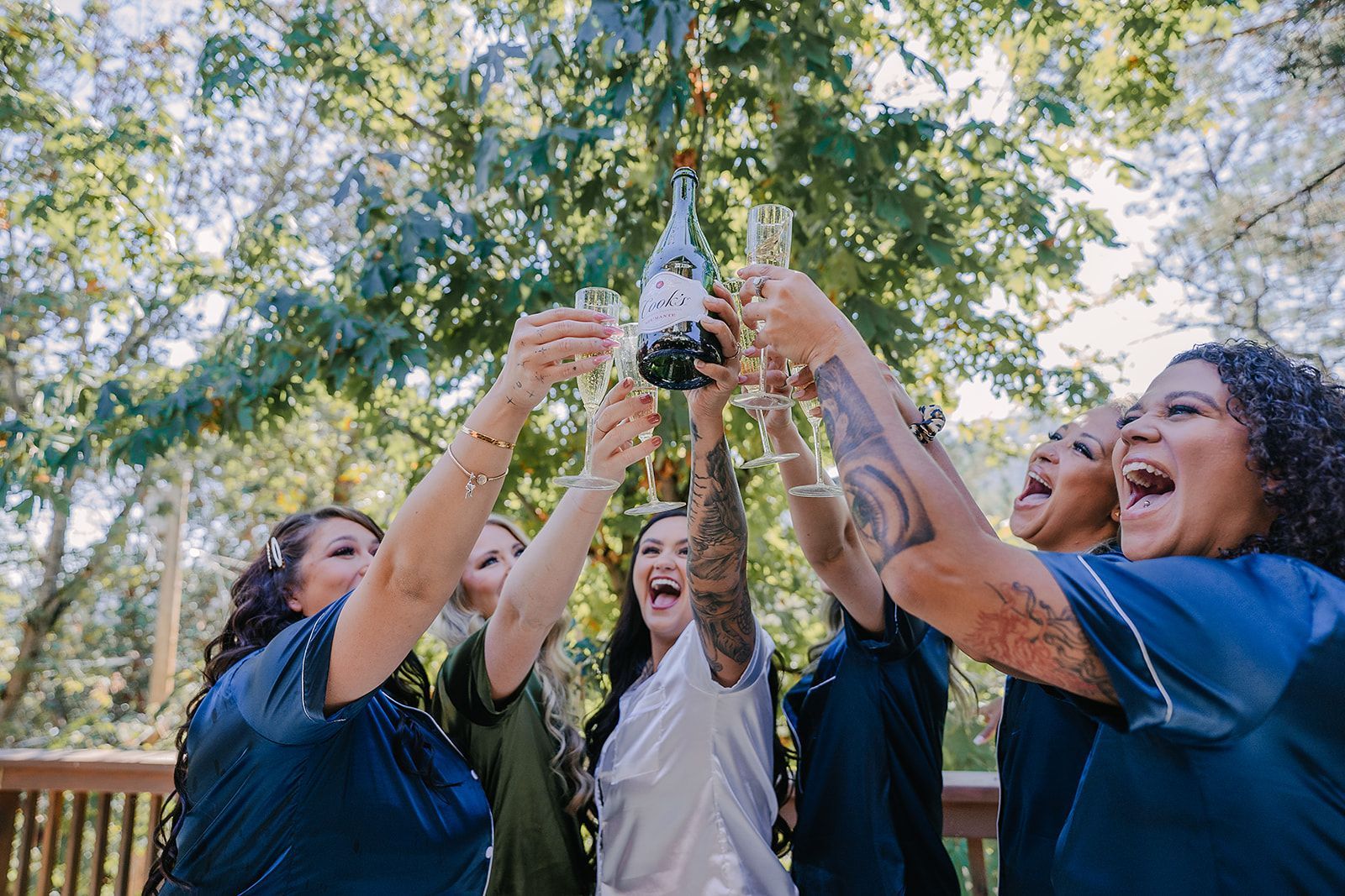 A bride and her bridesmaids are toasting with champagne.