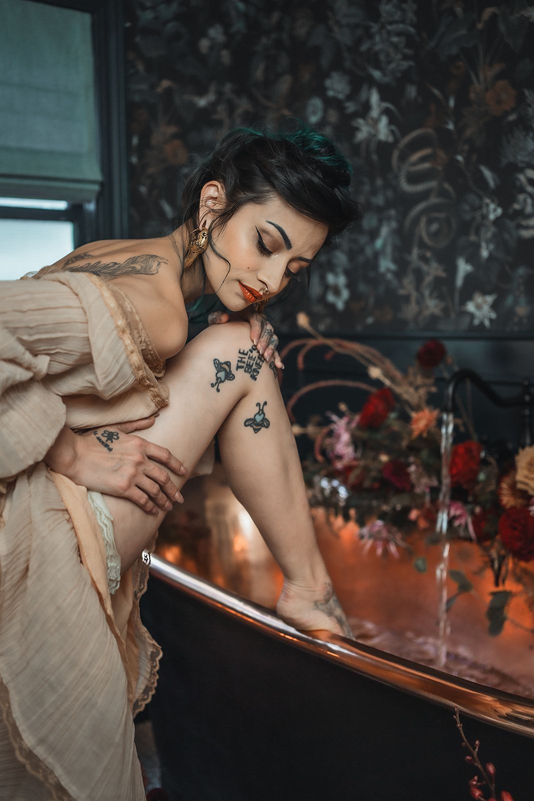 A woman is kneeling in a bathtub with her legs crossed.
