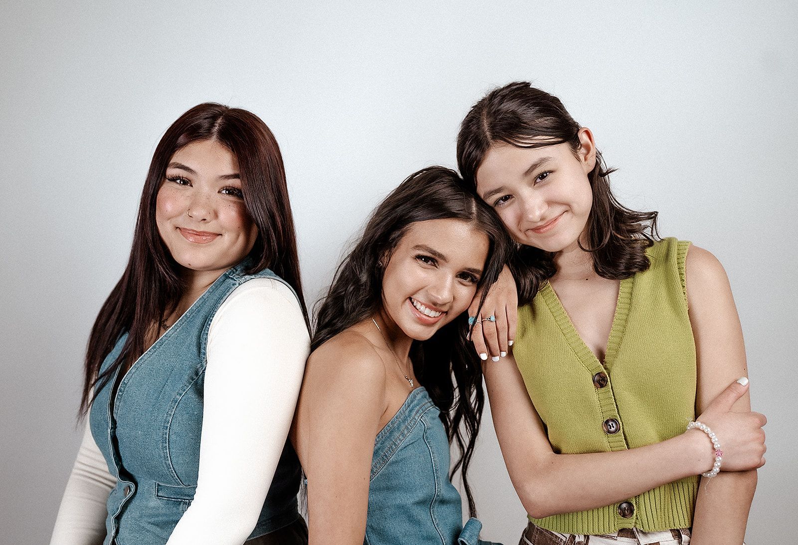 Three young women are posing for a picture together.