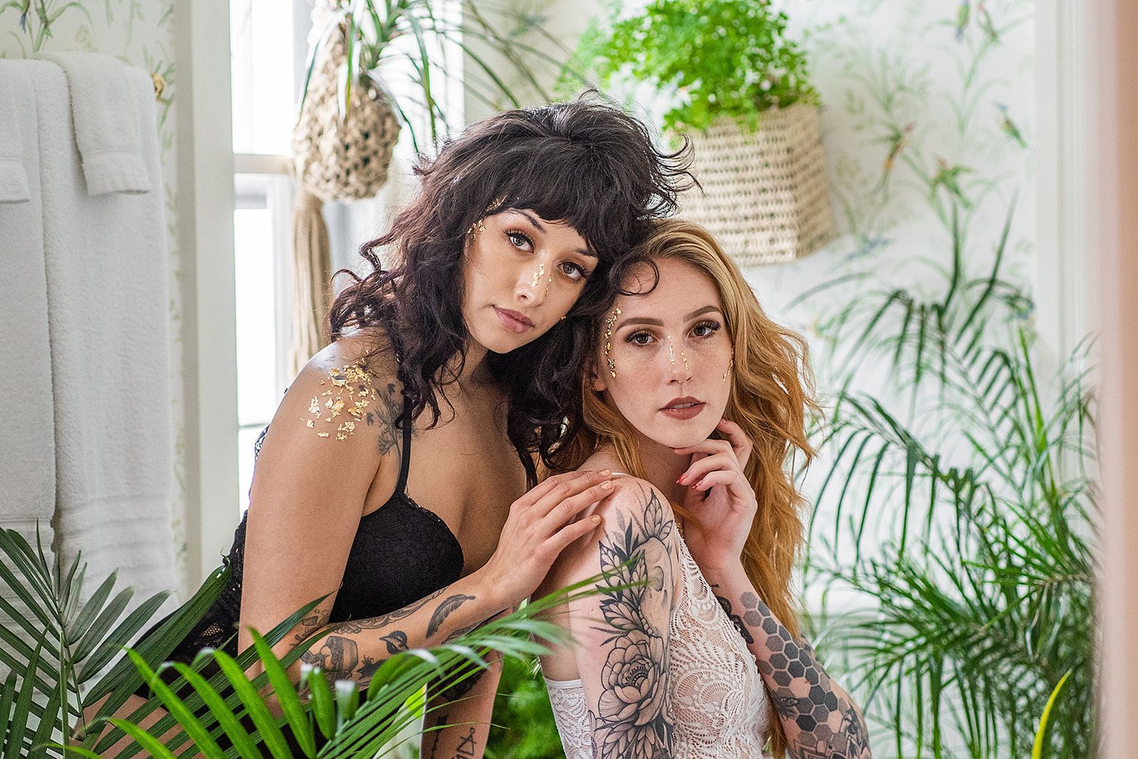 Two women are posing for a picture in a bathroom surrounded by plants.