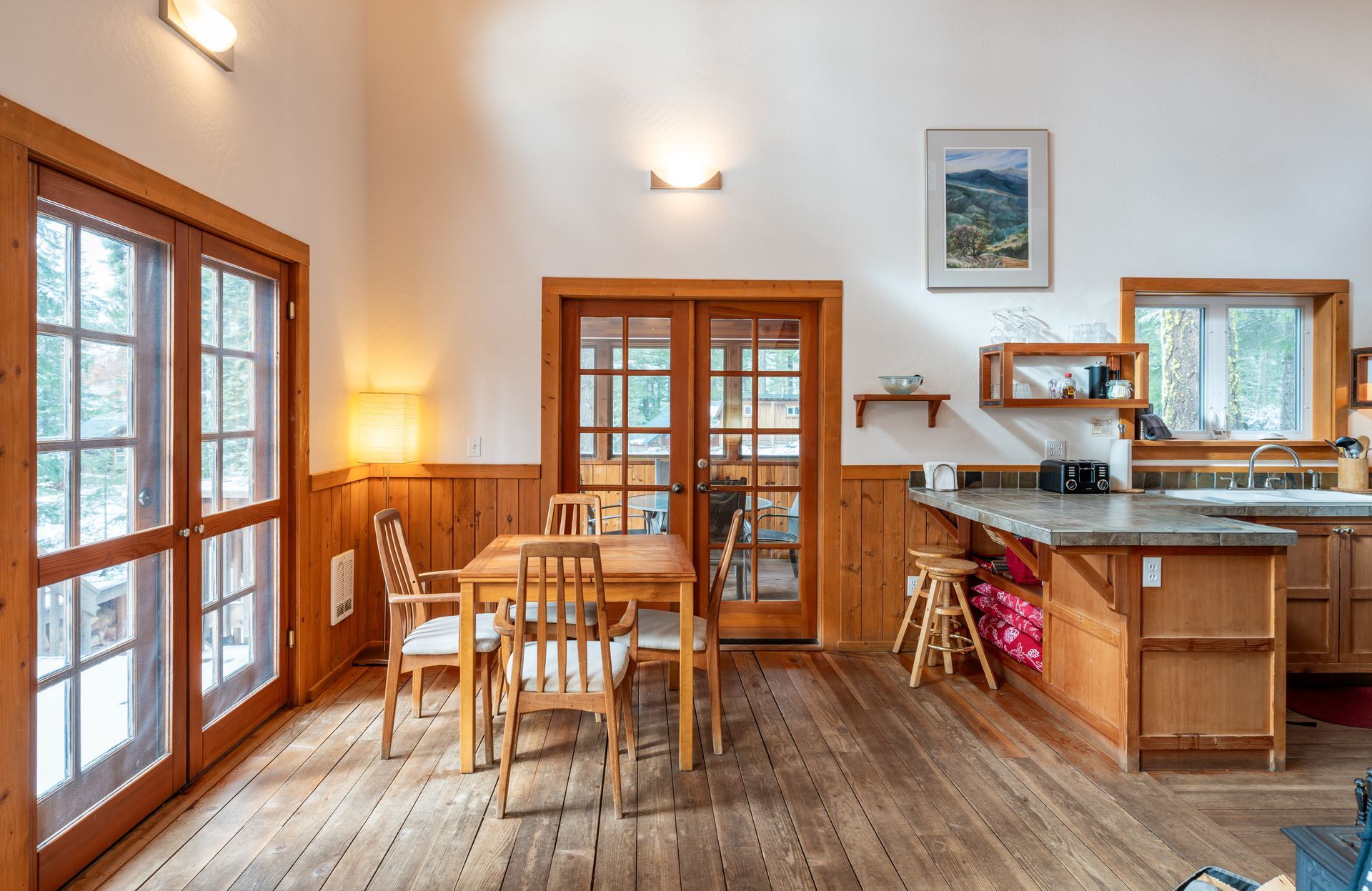 There is a dining table and chairs in the middle of the room.