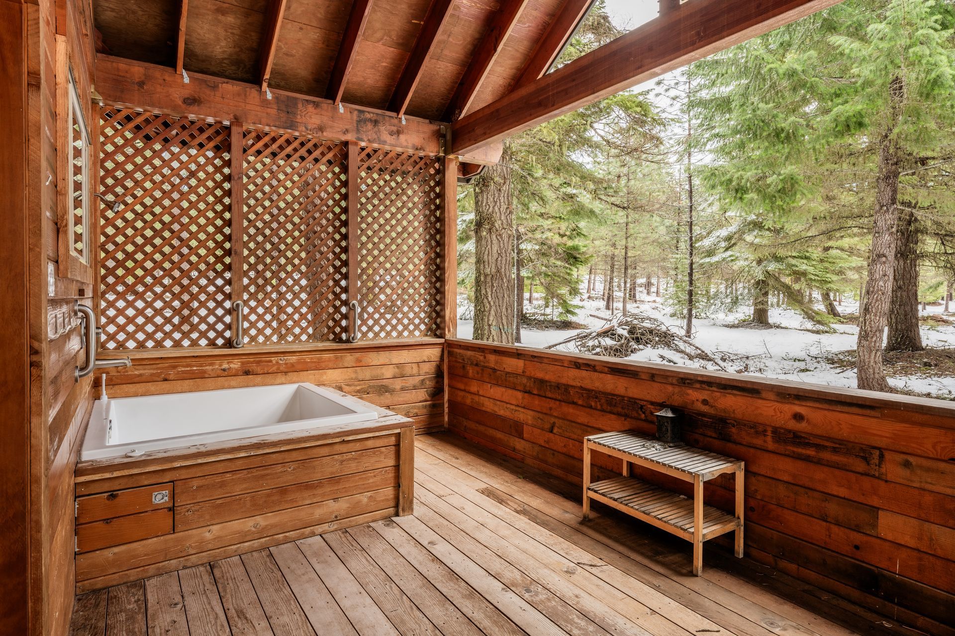 A wooden deck with a jacuzzi tub on it.