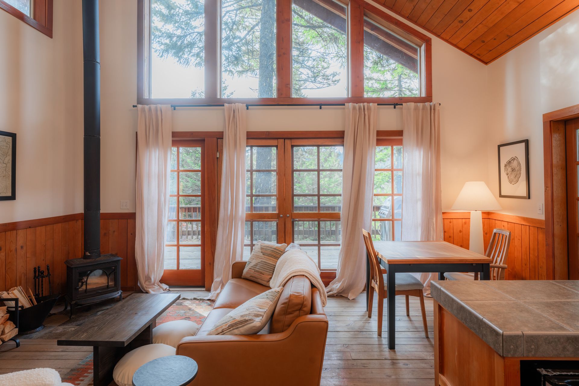 A living room with a couch , table , chairs and a fireplace.