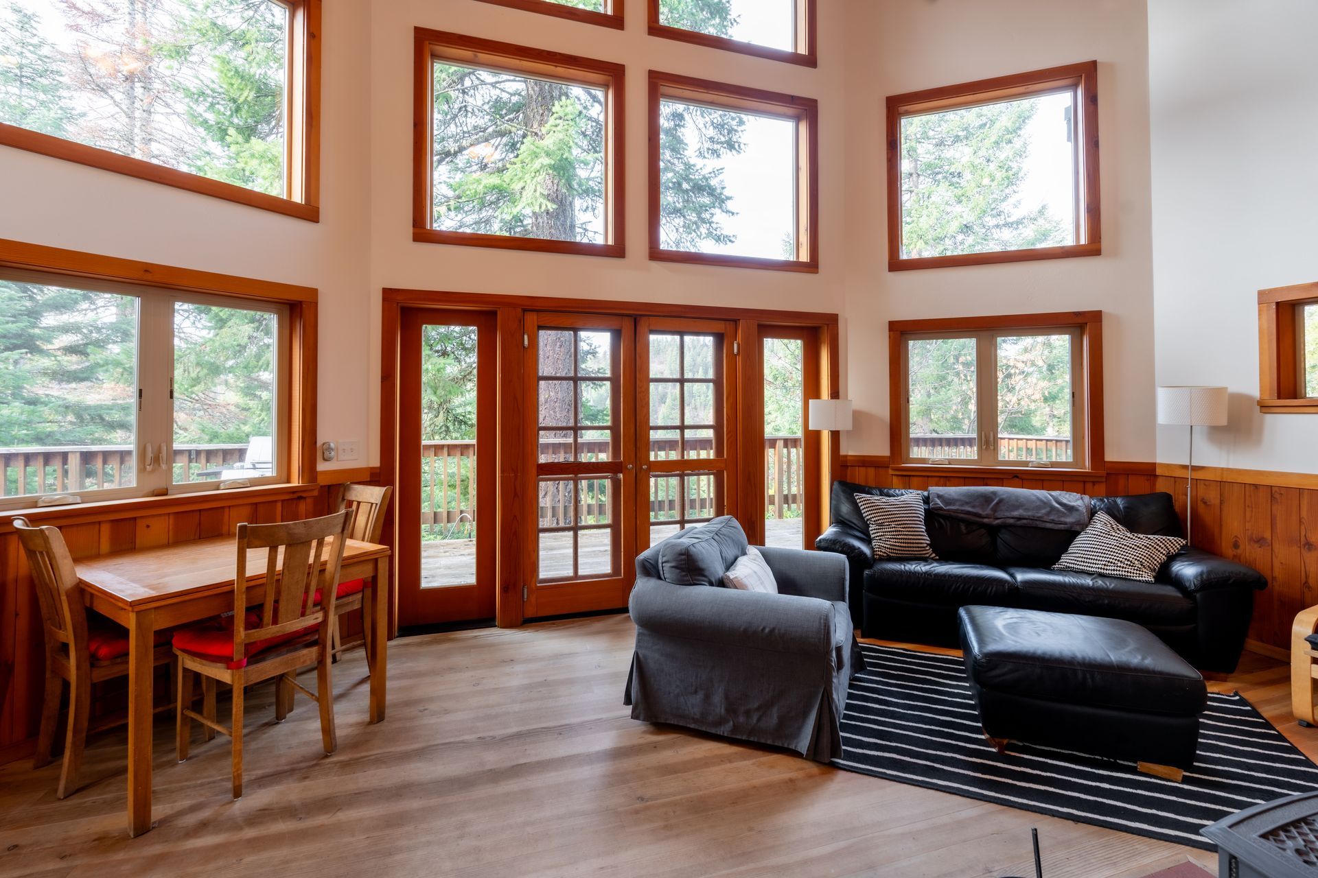 A living room with a couch , chairs , and a table.