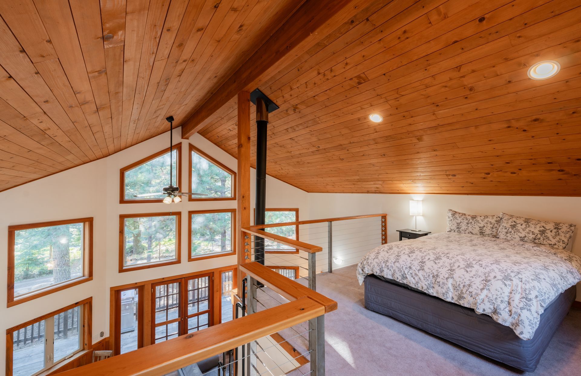 A bedroom with a king size bed and a wooden ceiling.