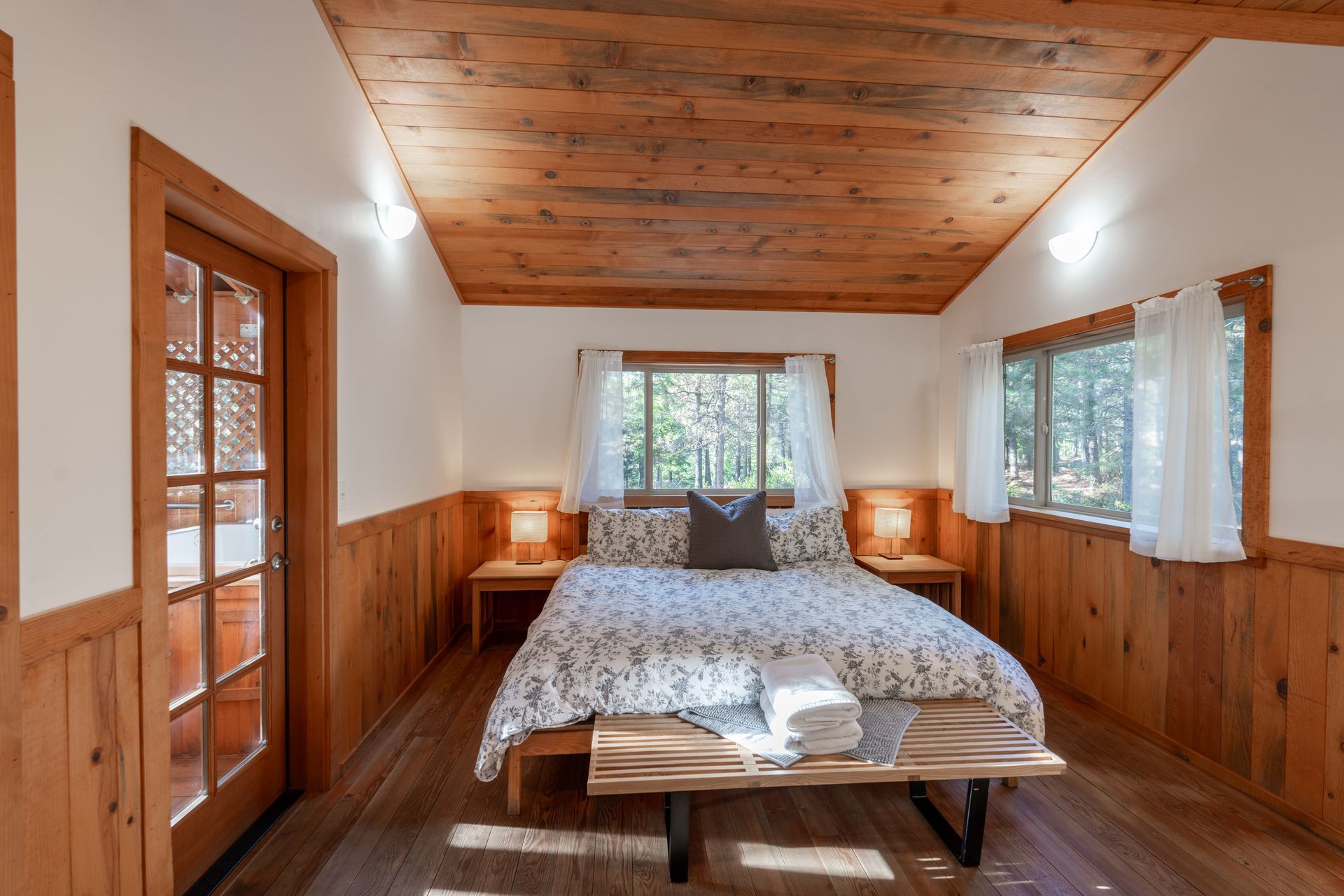A bedroom with a bed and a bench in it