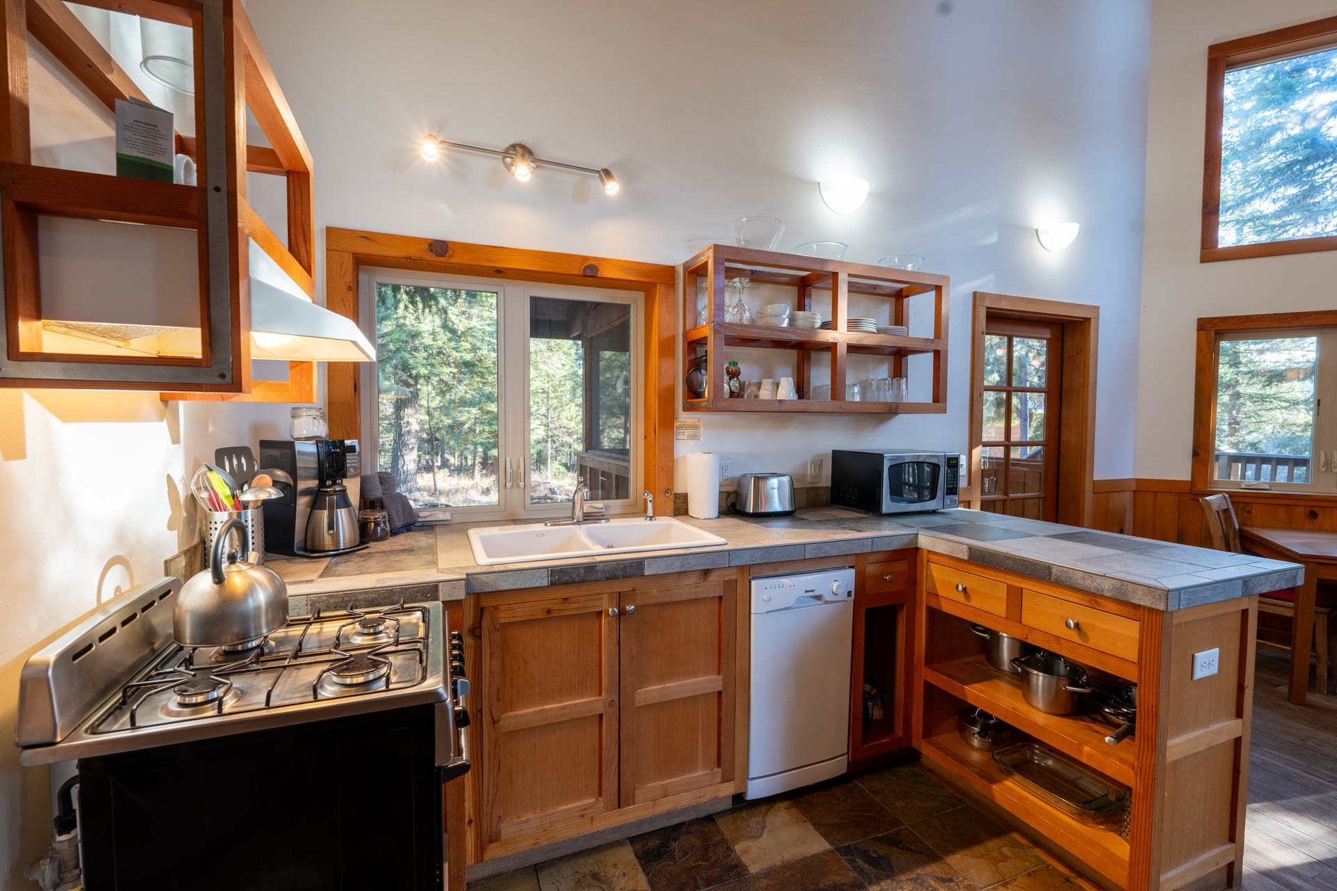 A kitchen with a stove , sink , and dishwasher.