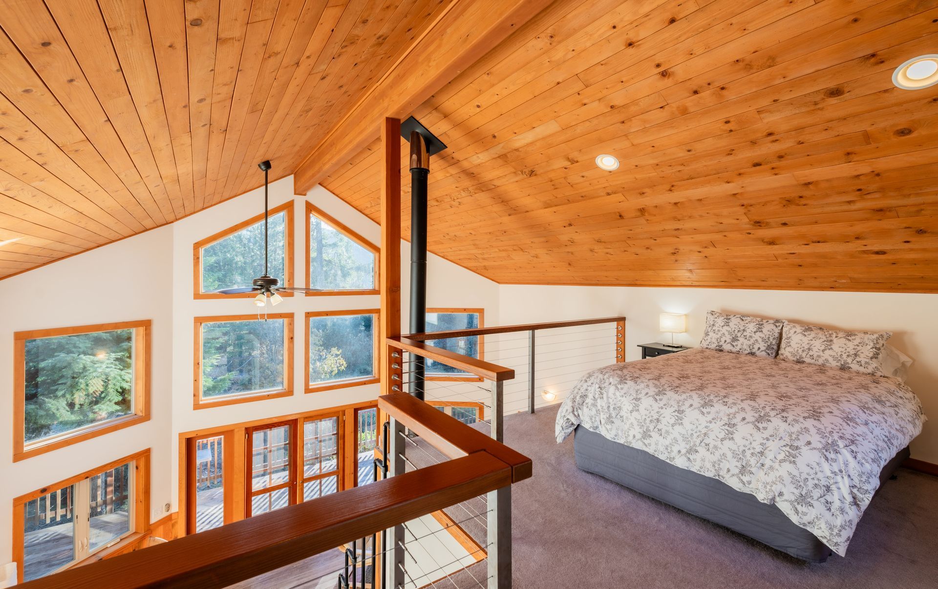 A bedroom with a bed and a wooden ceiling