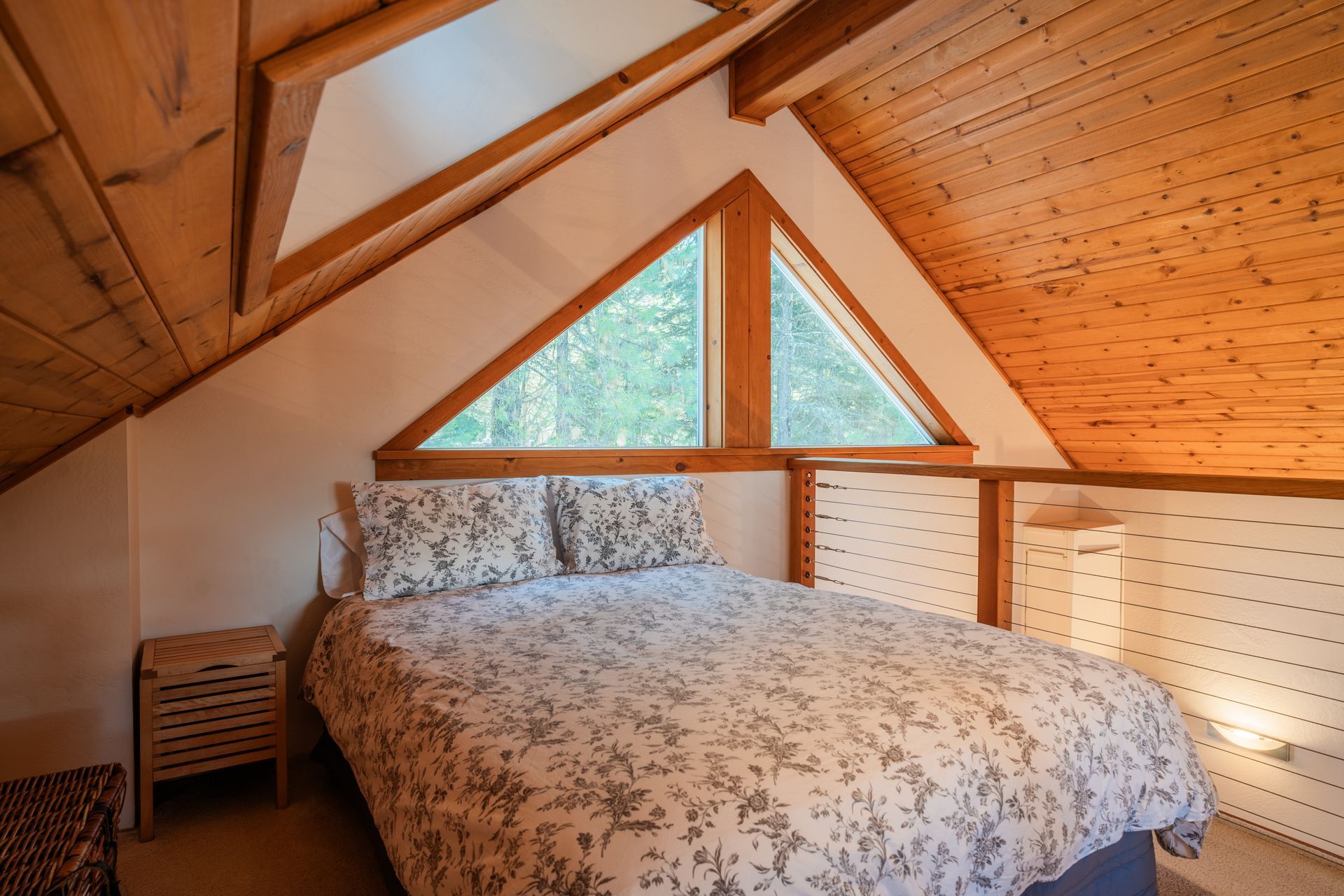 There is a bed in the attic of a house.